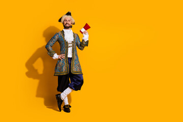 Cheerful nobleman in traditional attire holding a fan against a vibrant yellow background...