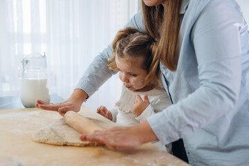 Two people. Mother and daughter are cooking on the kitchen