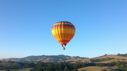 Obraz premium Colorful Hot Air Balloon Floating Above Scenic Rolling Hills Landscape