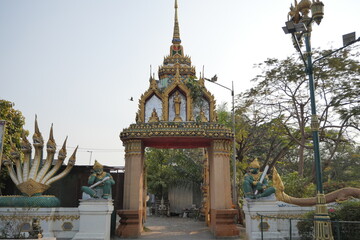 Fototapeta premium Gate at Wat King Kaew, Samut Prakan. Thai architecture, ornate details, temple entrance.