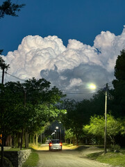 The storm is coming, the clouds loaded with water appear behind the mountains, threatening