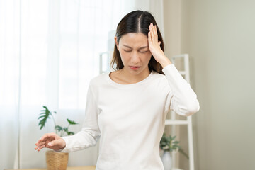 Dizzy asian young woman headache, migraine pain. suffering from vertigo, difficulty standing up...