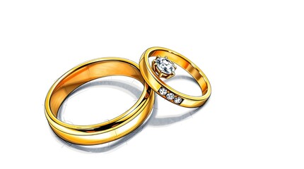 Two gold wedding rings resting on a surface with a warm glow in the background during a sunset.