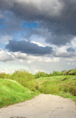 Road with a cloudy sky in the background