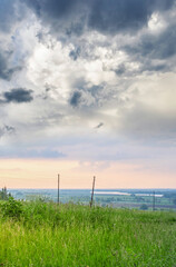Cloudy sky with a fence in the background