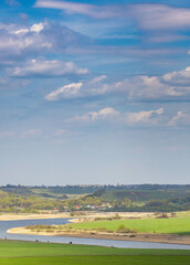 Beautiful landscape with a river and a green field