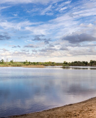 Calm lake with a cloudy sky in the background