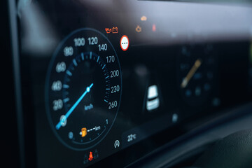 Vehicle is parked. Detailed close up view of speedometer, front panel