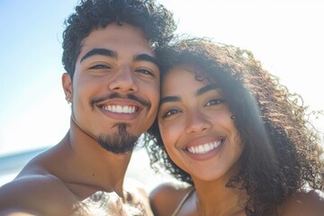 Young diverse biracial couple taking a selfie at the beach and having fun outside.