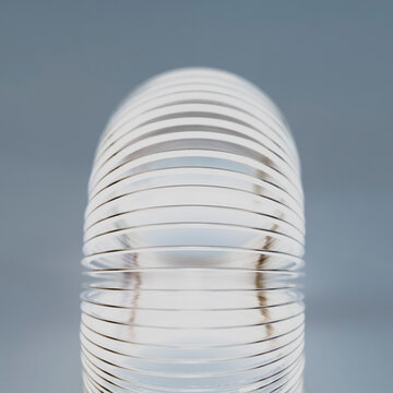 Abstract of metal coiled slinky, length of fine wire wound around and stretched, black and white image.