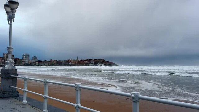 View of strong waves from the promenade of Gijon, Asturias, Spain.
