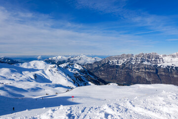 Snowy landscape with mountain panorama at ski resort Flumserberg in the Swiss Alps on a winter day....
