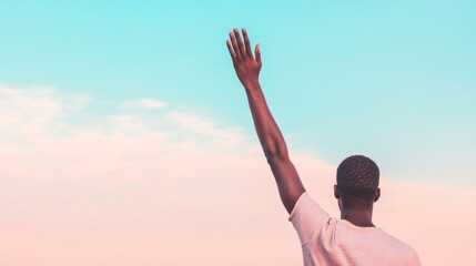 Obraz premium Man raising hand, pastel sky, freedom, hope, outdoor