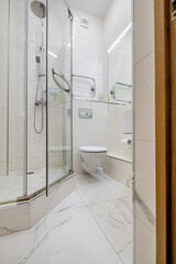 Modern Bathroom with Glass Shower and Marble Tiles
