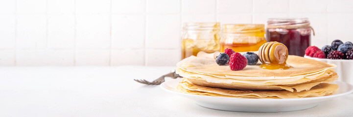 Traditional Maslenitsa food, Eastern European Slavic thin pancakes crepes, with various sweet...