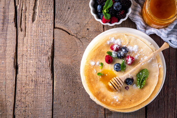 Traditional Maslenitsa food, Eastern European Slavic thin pancakes crepes, with various sweet...