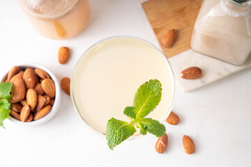 Sweet and sour lemon orgeat cocktail, Orgeat Lemonade Recipe, one martini glass with alcohol boozy drink and almond orgeat syrup bottle