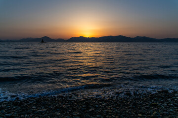 View of the sunset over the sea and island