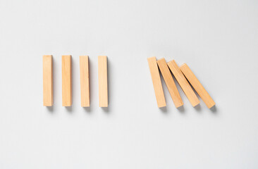 Domino effect. Wooden blocks on light background, flat lay
