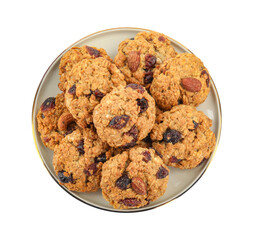 Delicious oatmeal cookies with dried cranberries and nuts isolated on white, top view