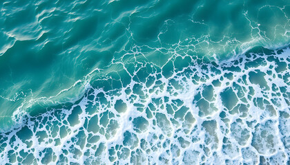 Fototapeta premium The ecology with Waves on the beach as a background. Beautiful natural background at the summer time-above view, realistic. with white shades