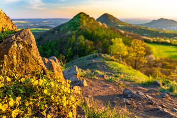 Sunset among the volcanic hills of the Bohemian Highlands, photographed from Brník hill, other hills are Srdov, Oblík and in the background is Raná peak