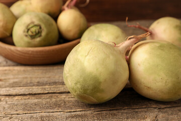 Whole fresh turnips on wooden table, closeup