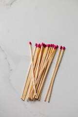 A pile of wooden matches with pink tips. Concept of warmth and comfort