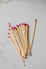 A pile of wooden long matches with pink tips