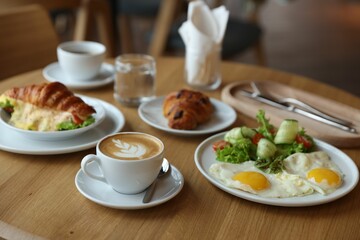 Delicious breakfast served on wooden table in cafe