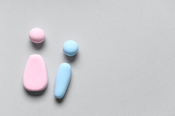 Male and female figures made of plasticine on grey background