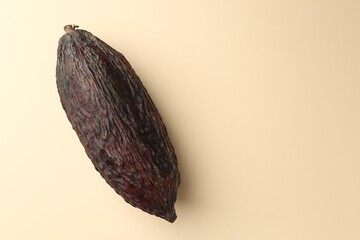 Cocoa pod on beige background, top view. Space for text