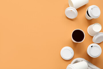 Disposable cups of coffee on beige background