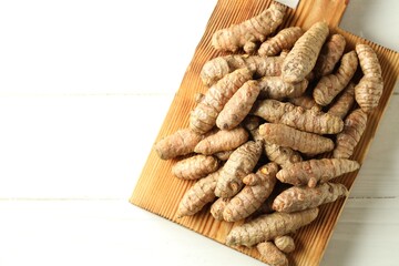 Tumeric rhizomes on white table, top view