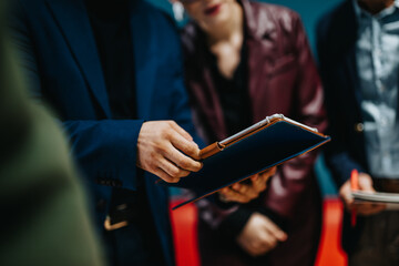 Focused professionals analyzing documents together in a business setting, collaborating on...