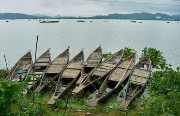Wooden boats on the shores of Deepor Beel in Guwahati, Assam, India