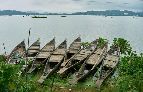 Wooden boats on the shores of Deepor Beel in Guwahati, Assam, India