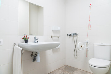 Modern geriatric nursing home bathroom with accessibility features