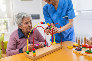 Elderly woman engaging in therapeutic activities with nurse