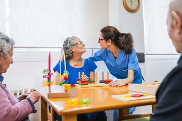 Caring nurse engaging with elderly residents in nursing home