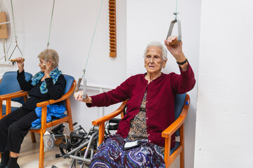 Elderly women engaging in physical therapy exercises