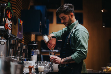A skilled bartender blends a drink behind the bar in a modern, stylish cafe. The image highlights a professional's craftsmanship, passion for mixology, and attention to detail during preparation.