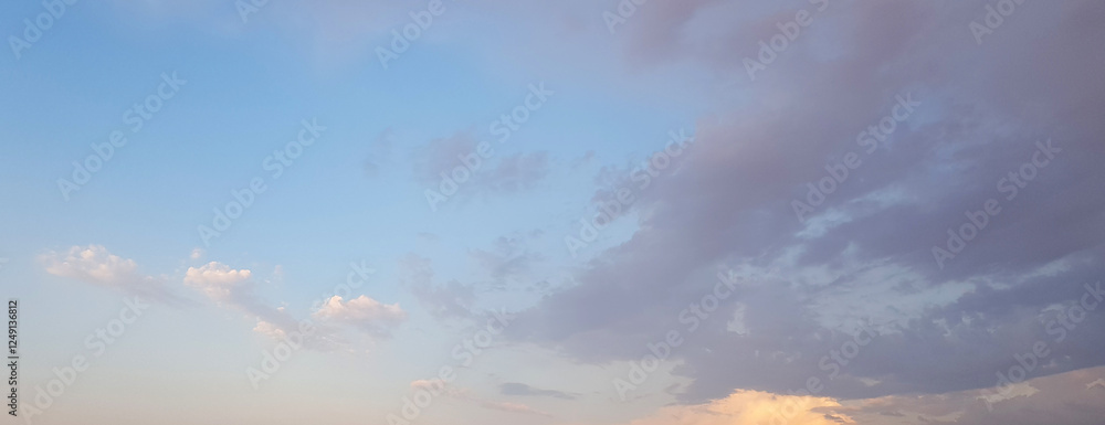 Wall mural beautiful sky, dawn background. blue sky with gentle pastel clouds and sun light