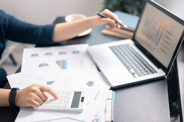 Finance bank tax expense accounting budget money businessman hand use calculator Financial calculate accountant close up calculator with graph chart write office desk Business expense analysis saving