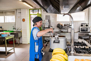 Chef preparing meals in nursing home kitchen