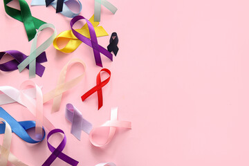 Composition with different ribbons on pink background. World Cancer Day