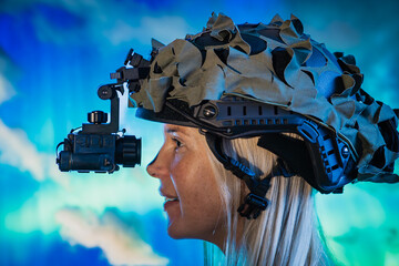 Woman in a military helmet with a thermal imaging monocular against the background of the night sky with the northern lights.