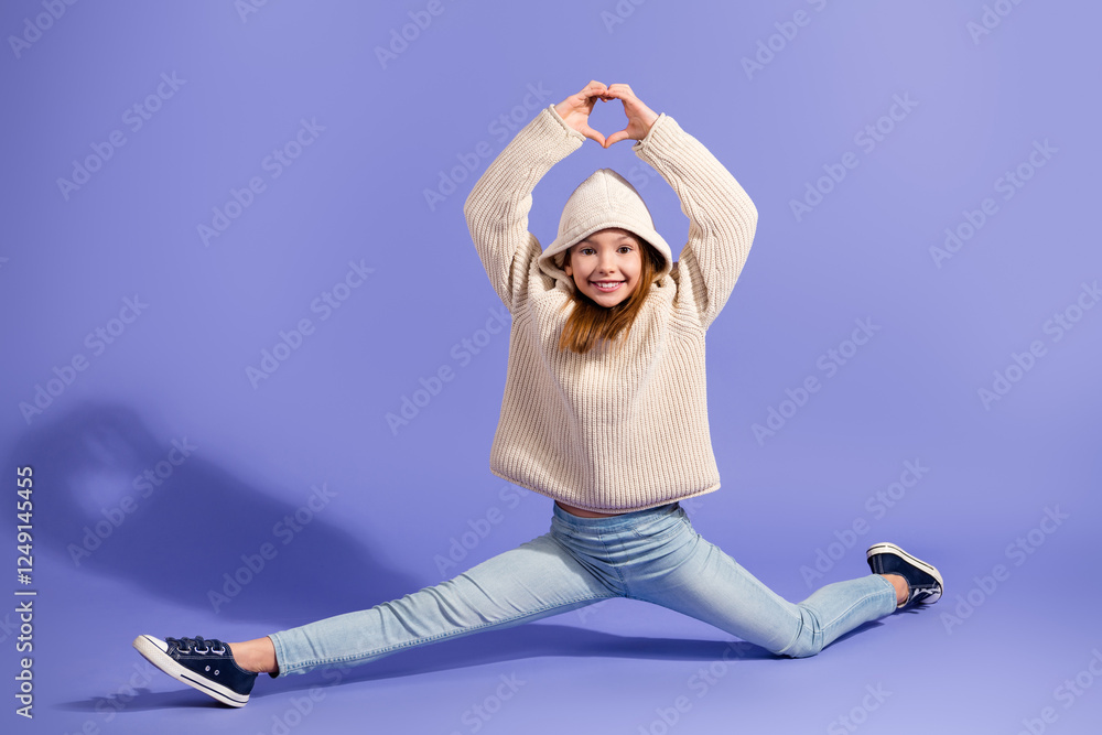 Wall mural Charming Young Girl Posing in Comfortable Sweater on a Violet Background, Smiling Joyfully