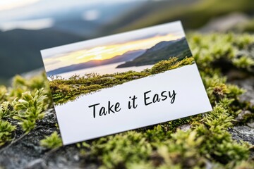 minimalist nature postcard, a modern, minimalist postcard featuring a tranquil sunrise over mountains, with the text take it easy in a stylish font