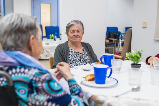 Elderly women dining in nursing home setting